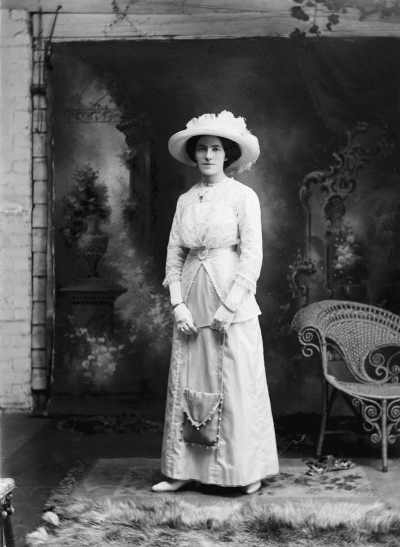 Studio portrait of Miss Meuleman [?] wearing a large hat.
