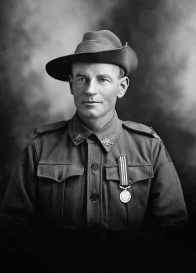 Studio portrait of Mr. Walker wearing an Australian Army uniform.