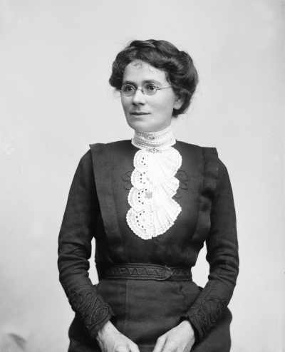 Studio portrait of an unidentified woman wearing spectacles.