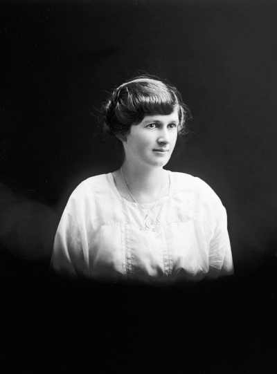 Studio portrait of a young woman in a white blouse.  Family name Irvine.