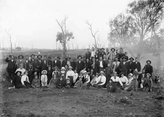 An unidentified group of people relaxing in a farmland environment.