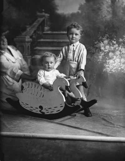 Studio portrait of young girl and boy. Family name Naughton.