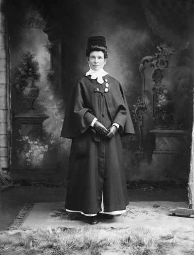 Portrait of Miss [or Mrs.] Moore wearinga nurses outdoor uniform.