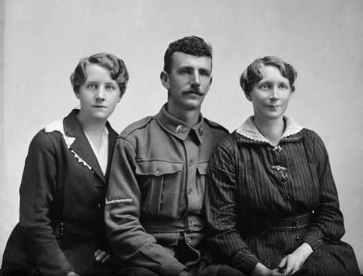 Portrait of two women with a man wearing an Australian Army uniform.  Family name Hamilton.