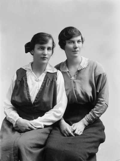 Studio portrait of two women wearing identical brooches.  Family name Tait.
