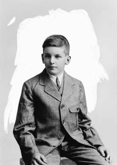 Studio portrait of a teenage boy wearing a three piece suit.  Familt name possibly Mitchell.