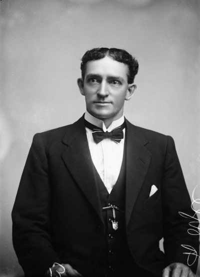 Studio portrait of Mr. Doyle wearing a suit.
