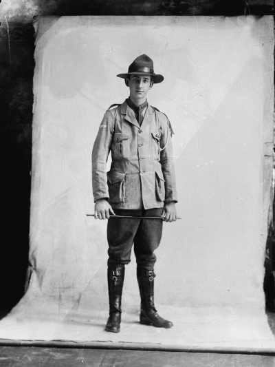 Studio portrait of a young man in an unidentifiable uniform.  Family name Lowe.