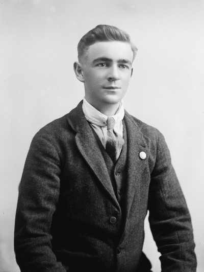 Studio portrait of a young man wearing a suit.  Family name Knowles.