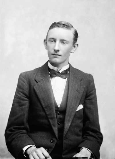 Studio portrait of a young man wearing a suit.  Family name Duffy.