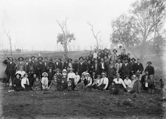 An unidentified group of people relaxing in a farmland environment.