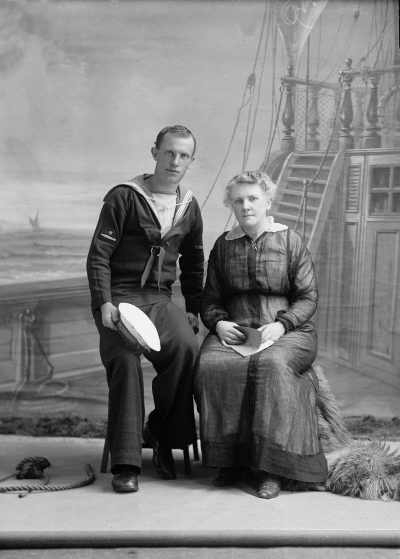 Portrait of a woman with a man in a sailors uniform.  Family name Baxter.