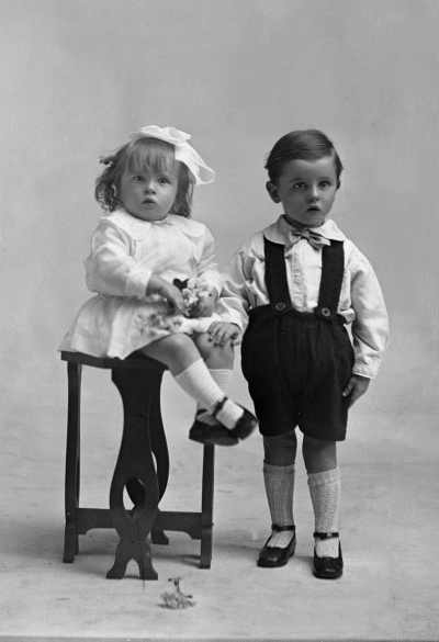 Studio portrait of a young girl and boy.   Family name possibly Rine.