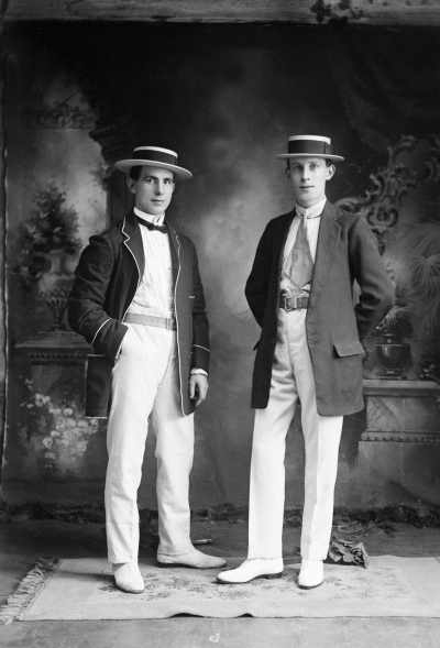 Studio portrait of two young men dressed in jackets and boater hats.  Family name Barr.