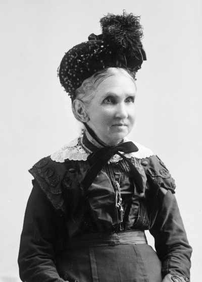 Portrait of  Mrs. Lugg wearing a hat.