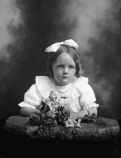 Half-length studio portrait of a girl.   Family name Carmody.