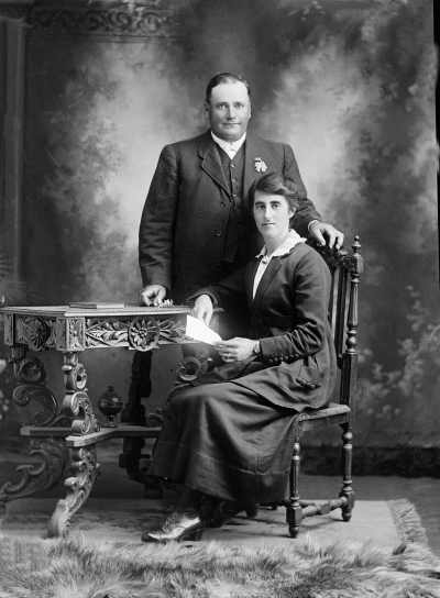 Studio portrait of a standing man and seated woman -  family name Newton.