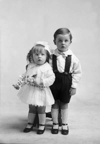 Studio portrait of a young girl and boy.   Family name possibly Rine.