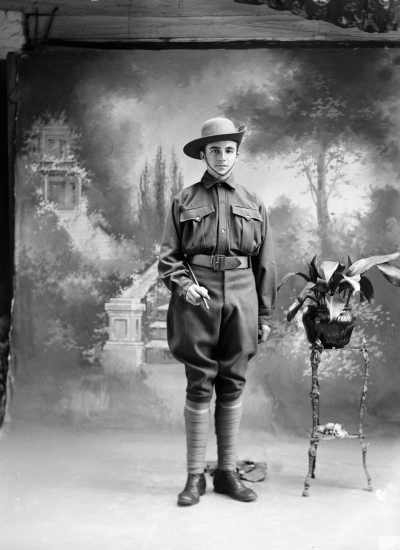 Studio portrait of a young man, family name Cronan, in a cadet army uniform.