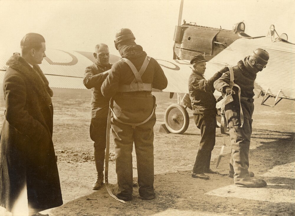 Two men being fitted with flying suits