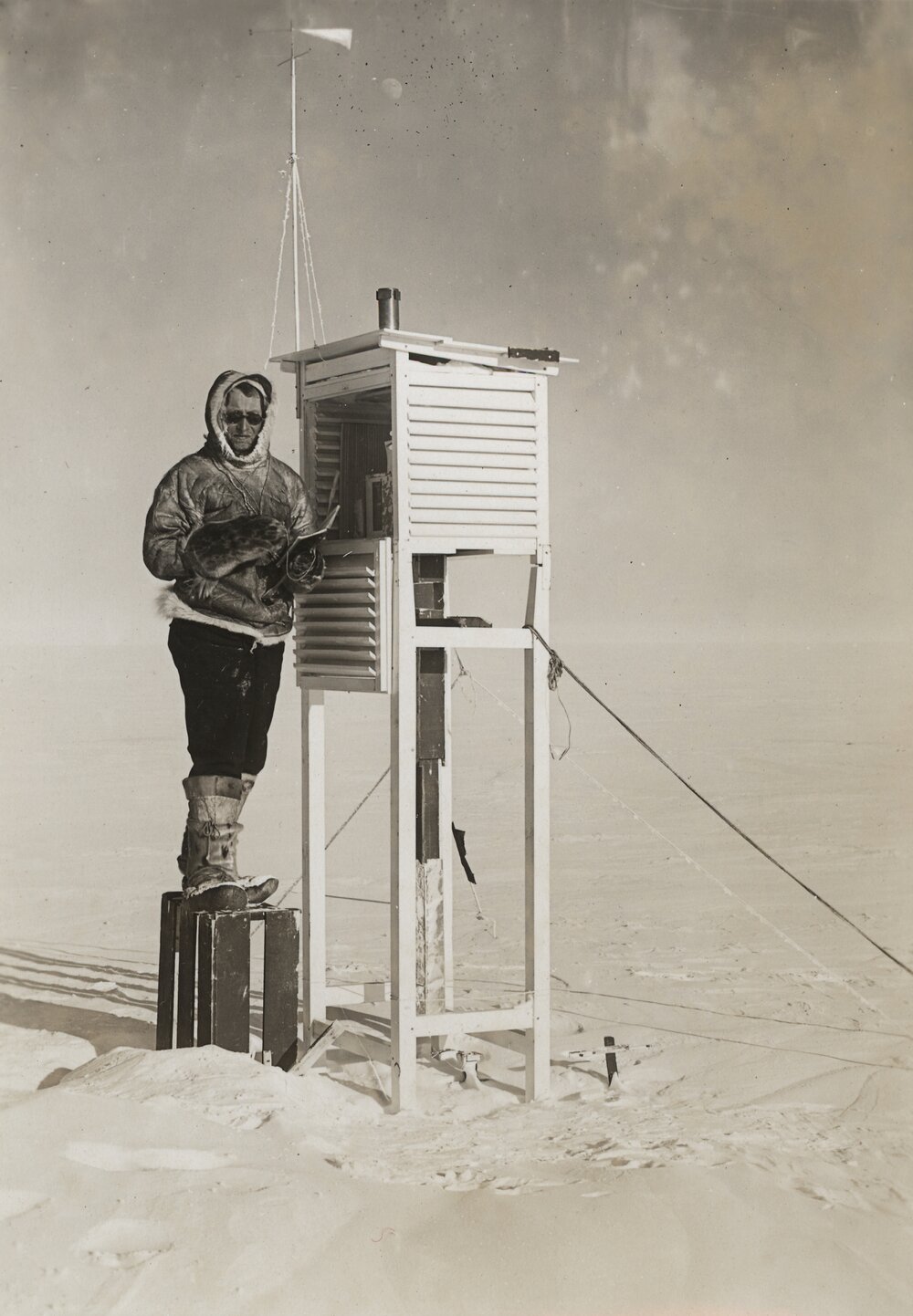 Expedition member standing at weather observation structure