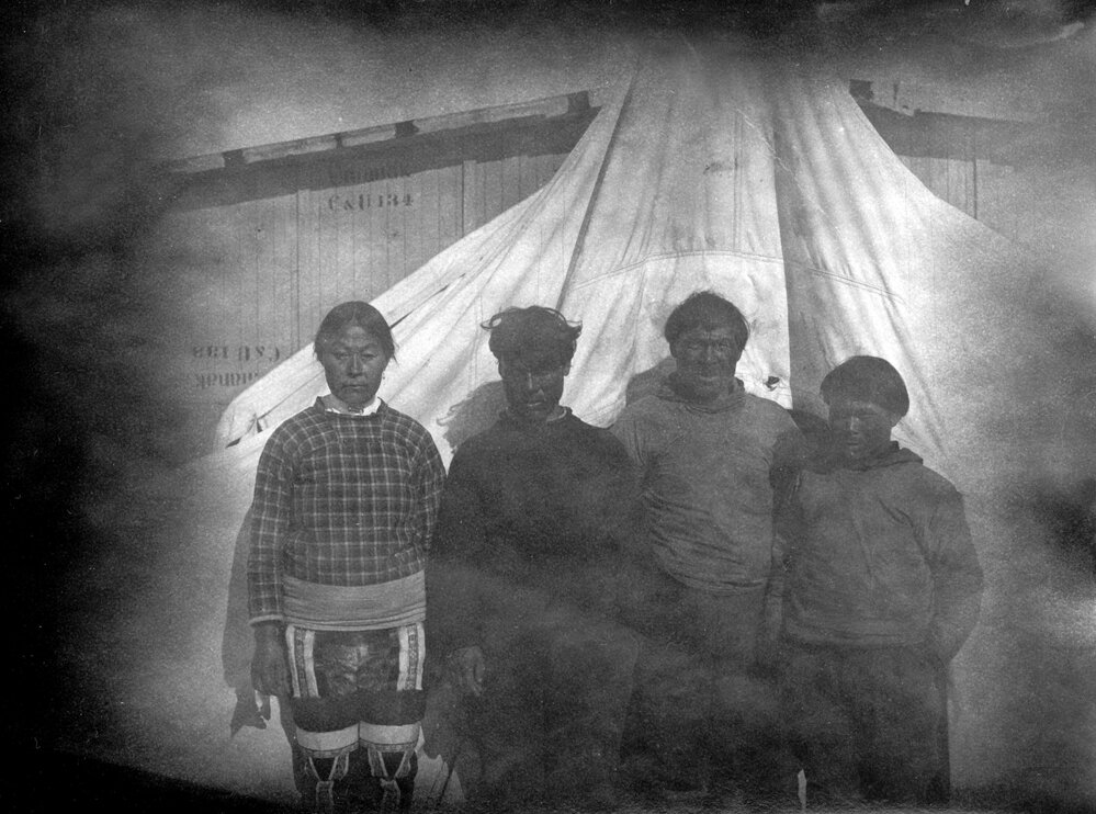 Kamarujuk station hut with unidentified Greenlanders  standing outside