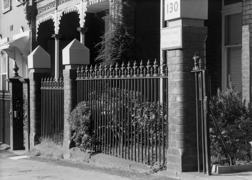 An iron, brick and bluestone fence in Nicholson Street, Fitzroy, Melbourne.