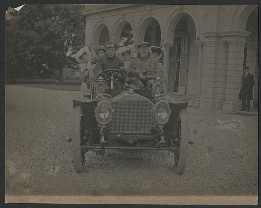 Front view of Reid Family in car at "Rostrevor".