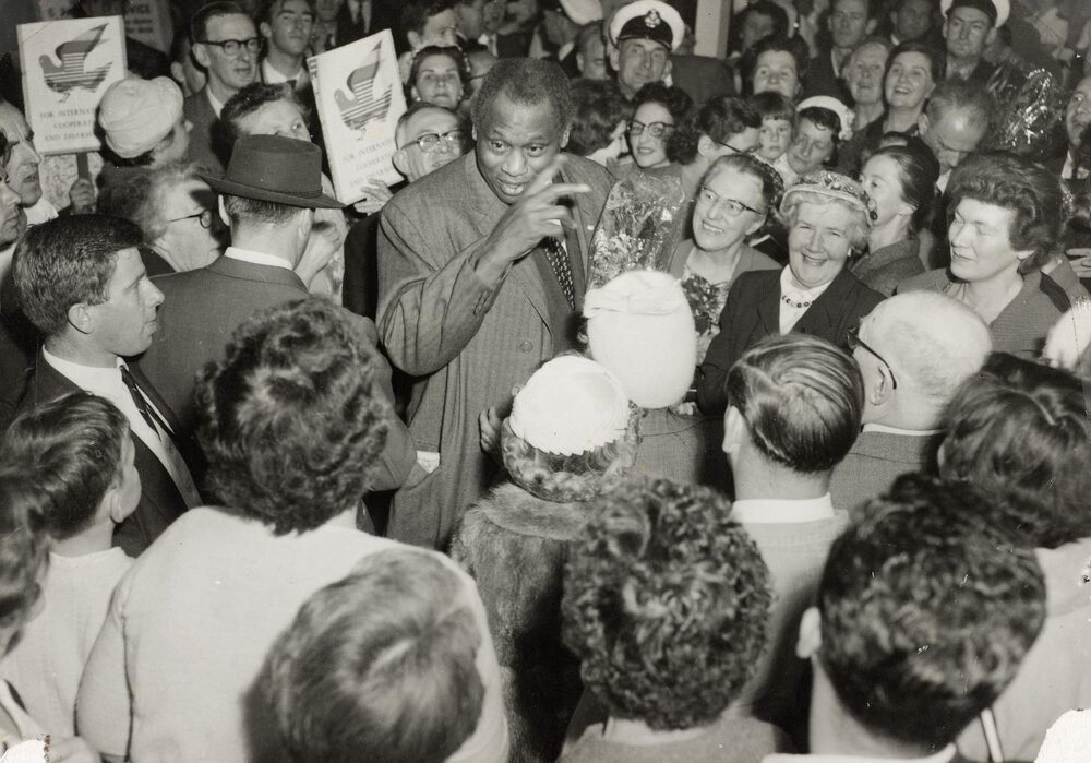 Paul Robeson being welcomed by friends and admirers at a reception in Melbourne in 1960.