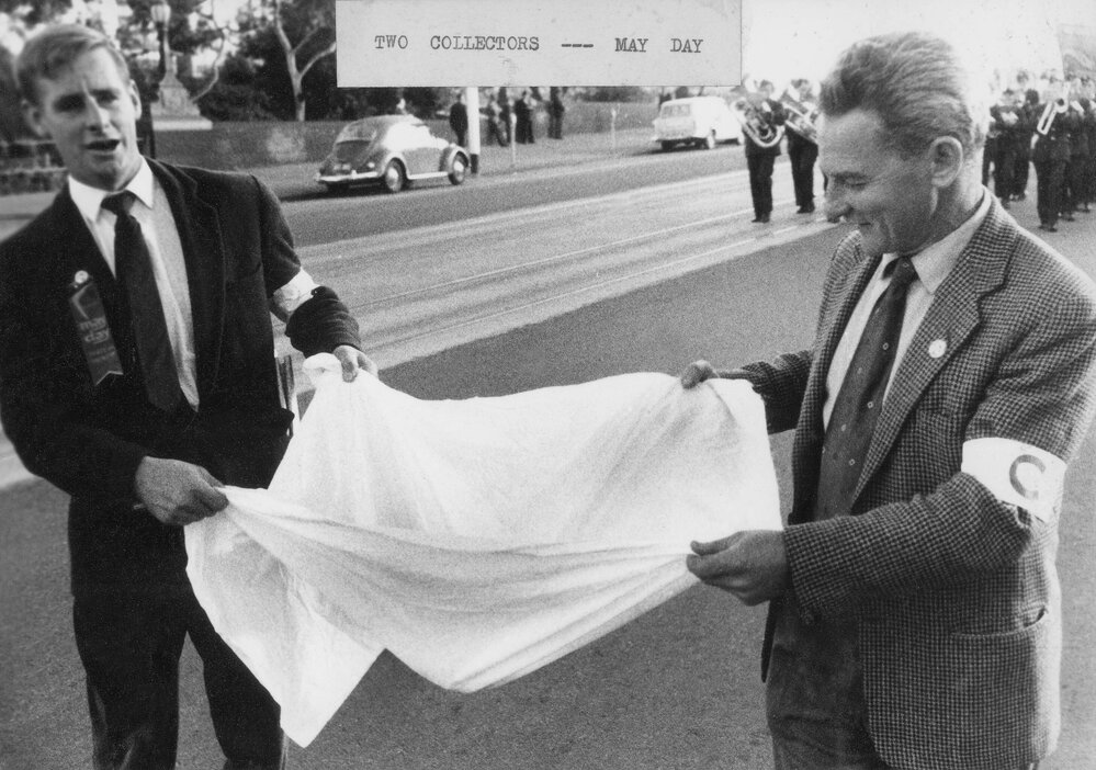 Two men collecting money during a May Day march in Melbourne.