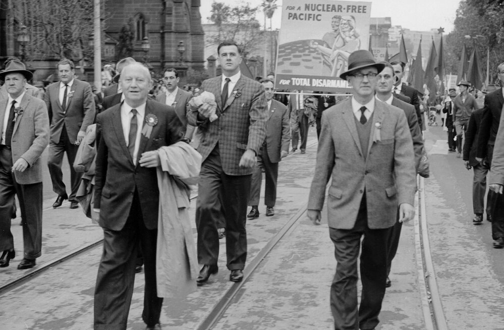 Men parading with banners at a May Day March in Sydney.