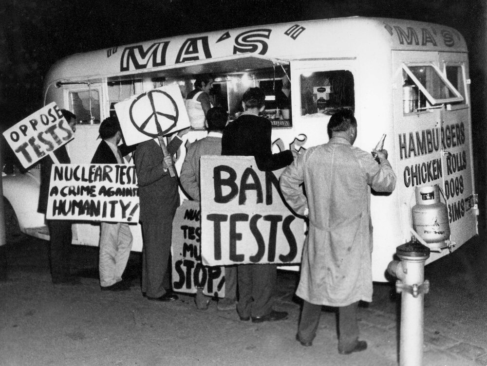 Anti-nuclear test protesters at a take-away food van, during a rally in Melbourne.