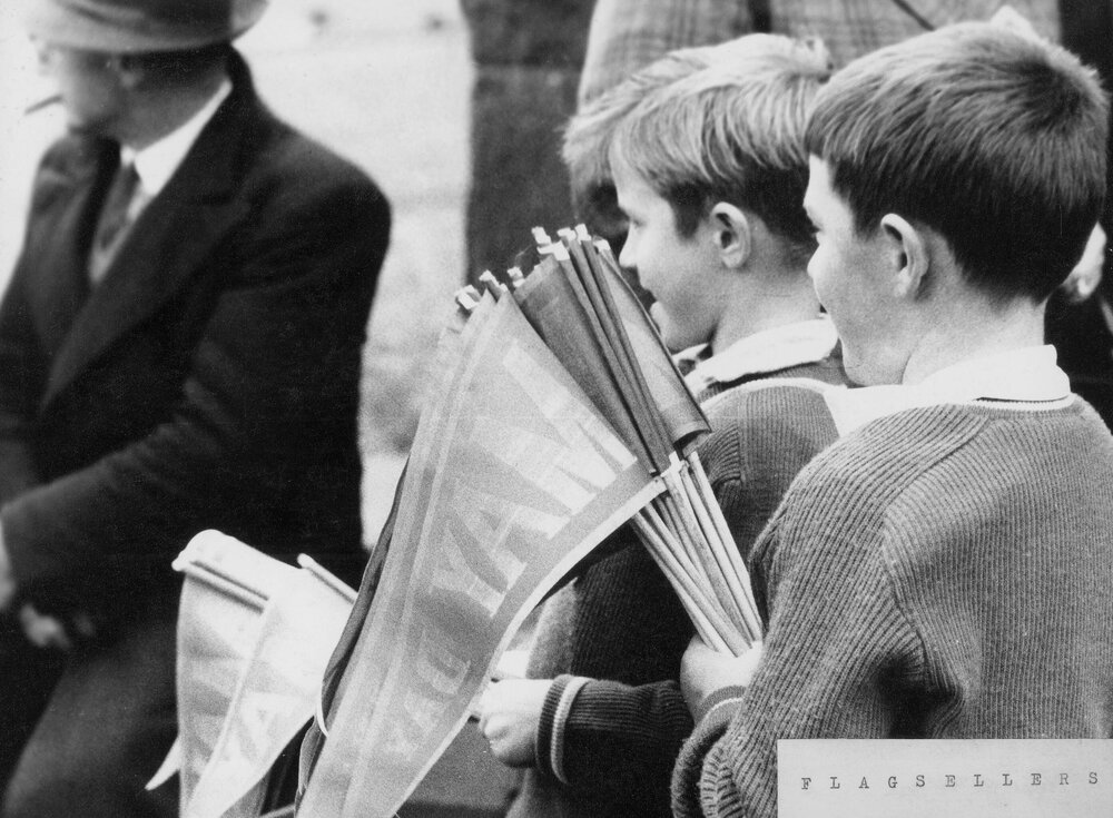 Young boys selling flags in Melbourne on May Day.