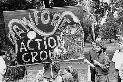 "Rainforest action group" banner at the People for Nuclear Disarmament Palm Sunday Rally, April 1990.