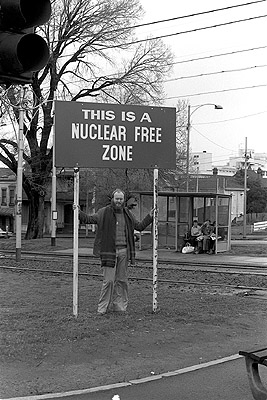 Andrew Hewett beneath Nuclear-Free sign, August 1978