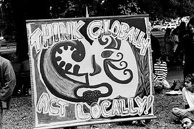 "Think globally, act locally" banner at the People for Nuclear Disarmament Palm Sunday Rally, April 1990.