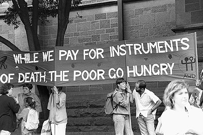 "While we pay for instruments of death the poor go hungry" banner outside U.S. consulate during Persian Gulf war protest, 14 January 1991.