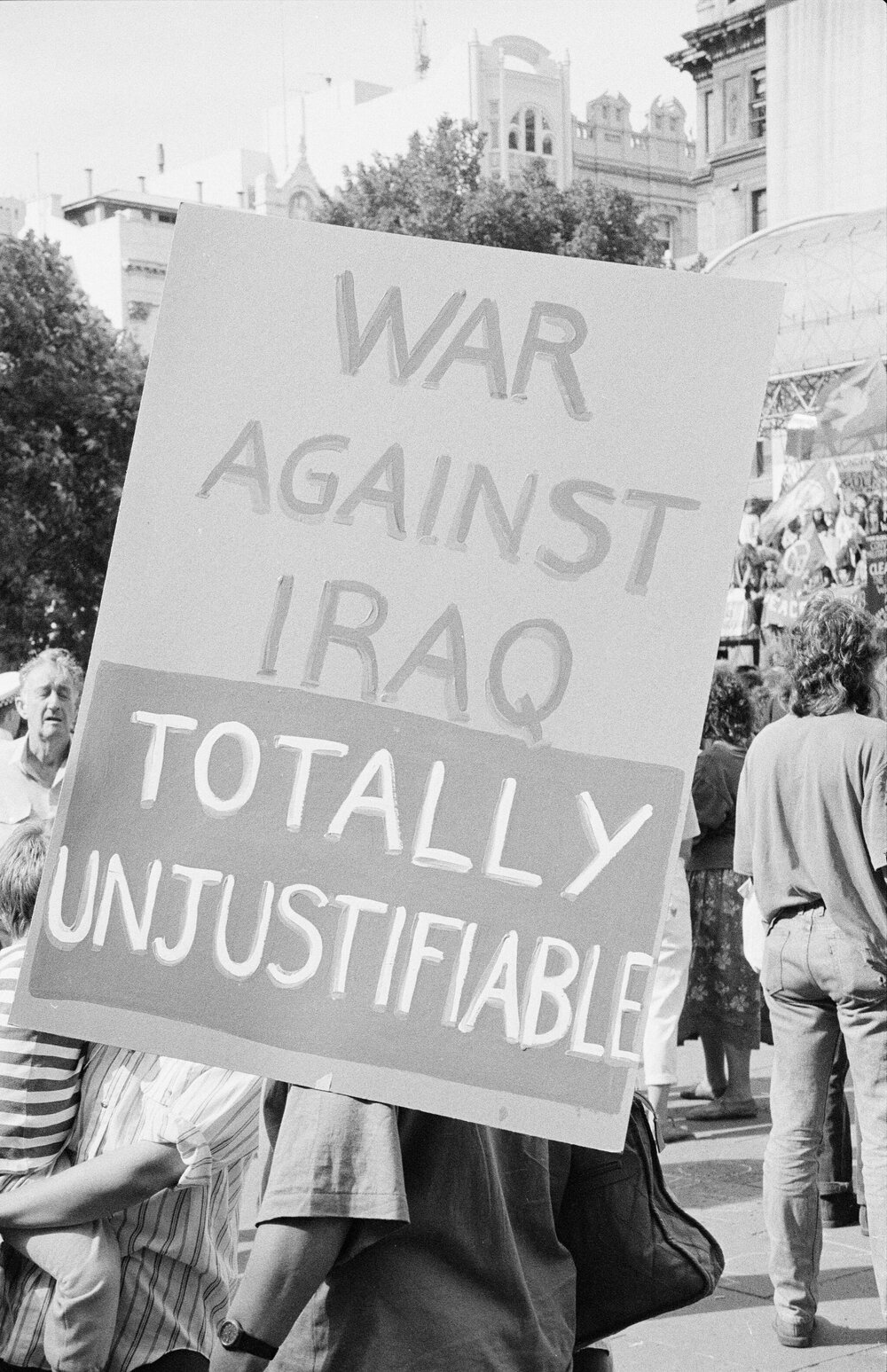 "War against Iraq totally unjustifiable" poster outside U.S. consulate during Persian Gulf war protest, 14 January 1991.