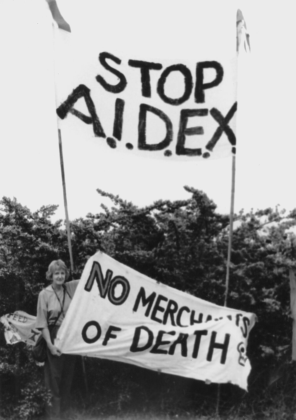 Joan Coxsedge holding "Stop AIDEX" banner at the Australian International Defence and Equipment Exhibition (AIDEX) protest, Canberra, 26 November 1991.