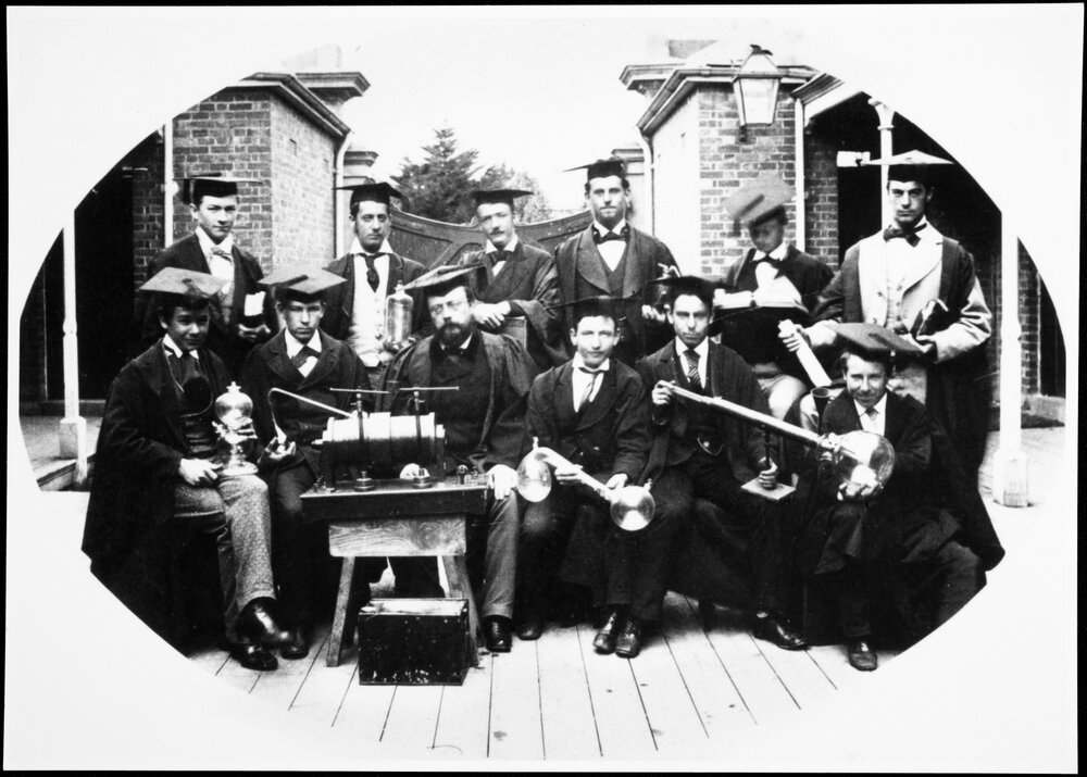 Kirkland, Professor J.D, among a group of science graduates, complete with instruments