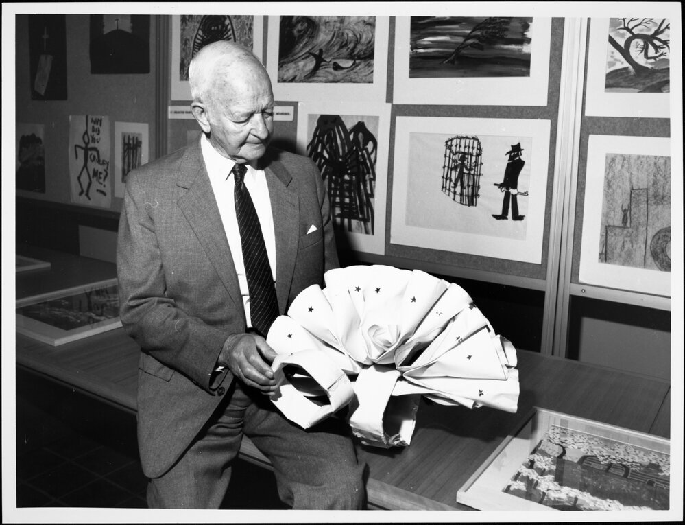 Dax, Dr Eric Cunningham, with one of the works from the Psychiatric Art Collection, Horsham Regional Art Gallery.