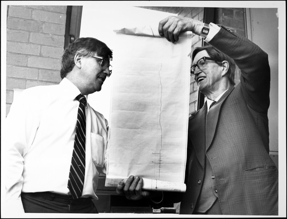 Wood, Dr David (left), Chairman of the Department of Chemical Engineering &nbsp;and Bill Martin with a temperature chart of the reaction which converts titanium tetrachloride to titanium steel. Sep 1987