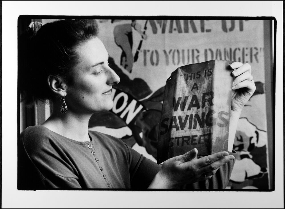 University Library Archives. Iris Kemp with &lsquo;War Savings Street&rsquo; sign