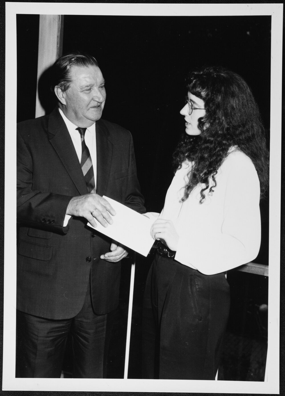 University Library - Events.  Arts student Mairi Milne receiving $1,000 Western Mining Corporation Prize for Archival Research, from Chairman of WMC, Sir Arvi Parbo, in a ceremony at the Library. 1994