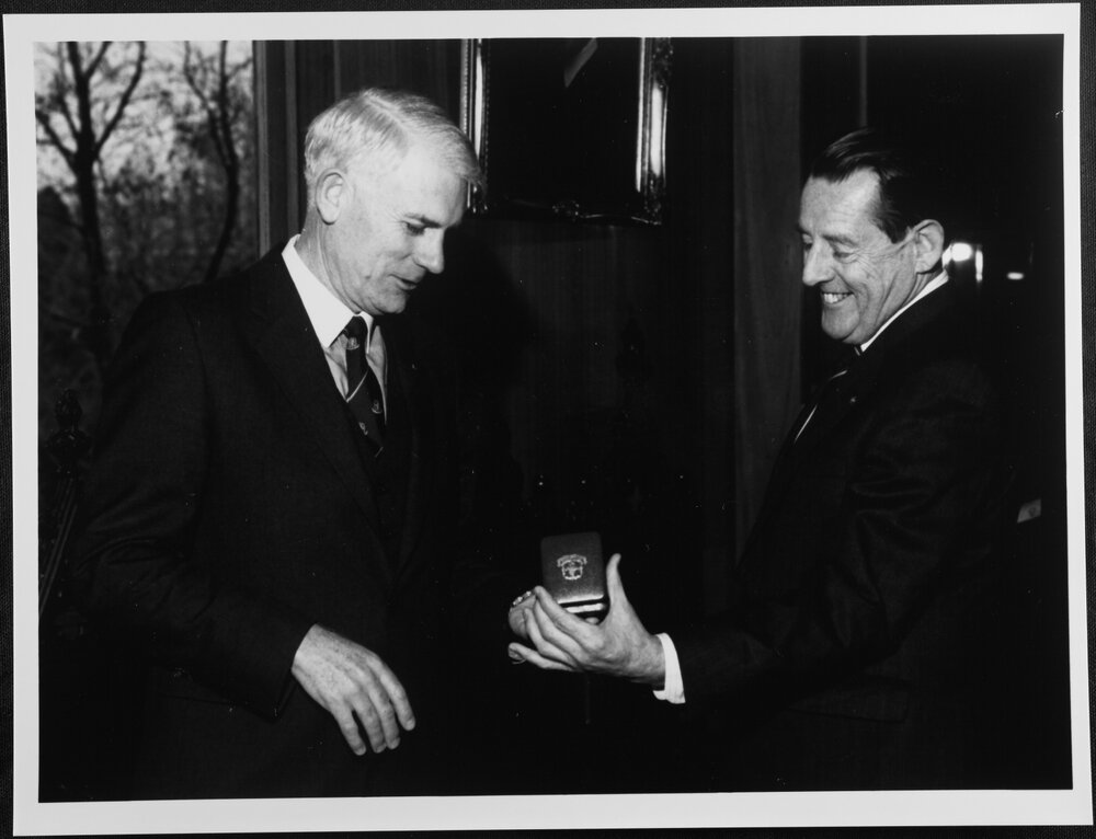 Pawsey, Maurice showing medal to J B. Potter