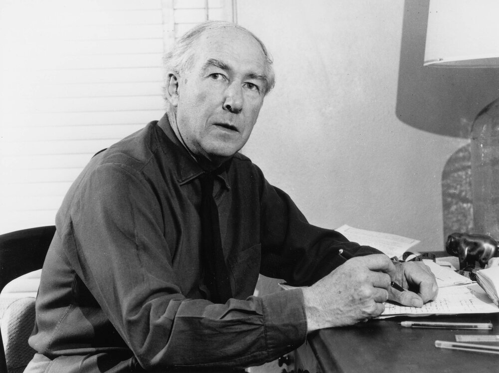 Portrait of the poet A.D. Hope writing at a desk.