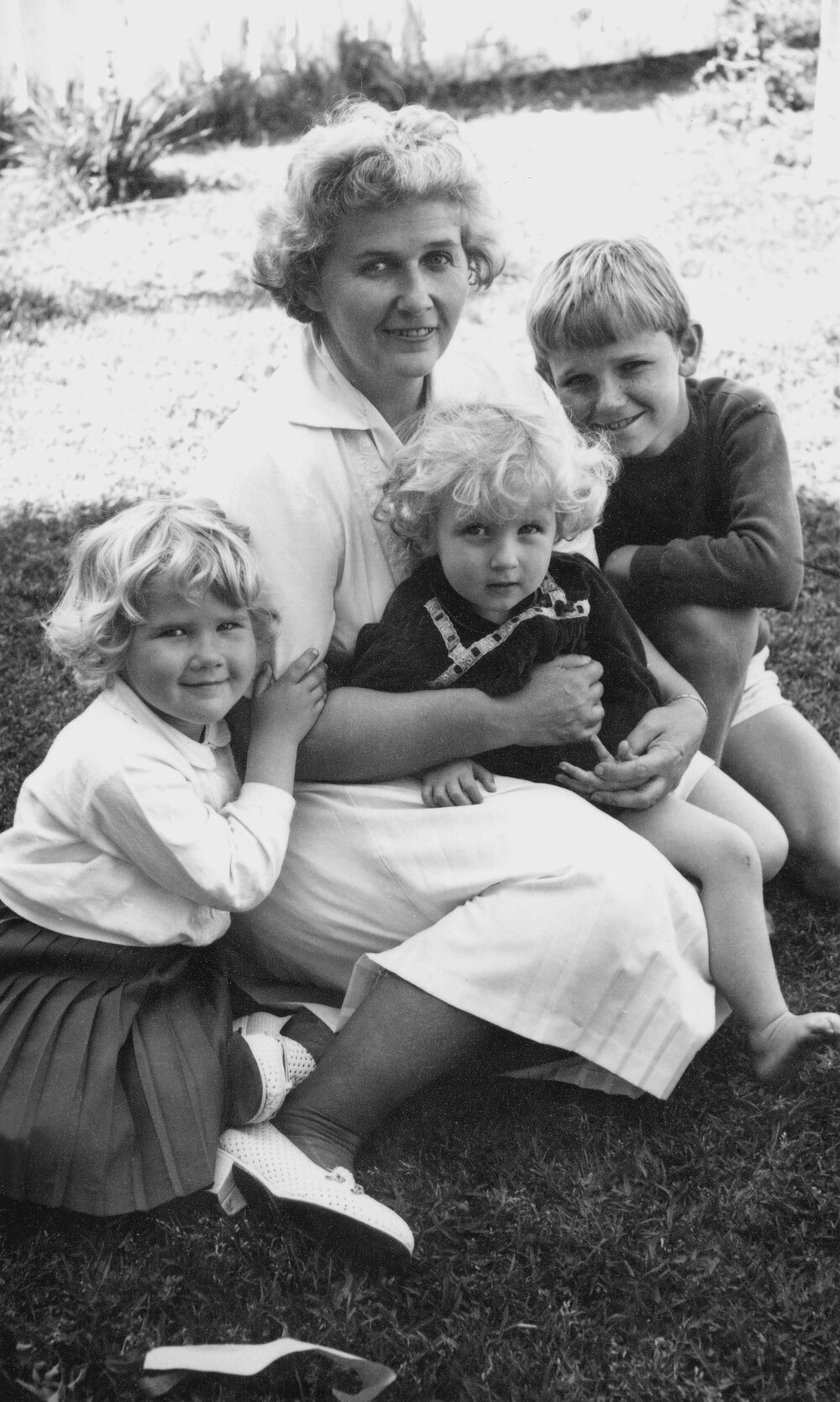 An outdoor portrait of Dorothy Hewett with her three young children.