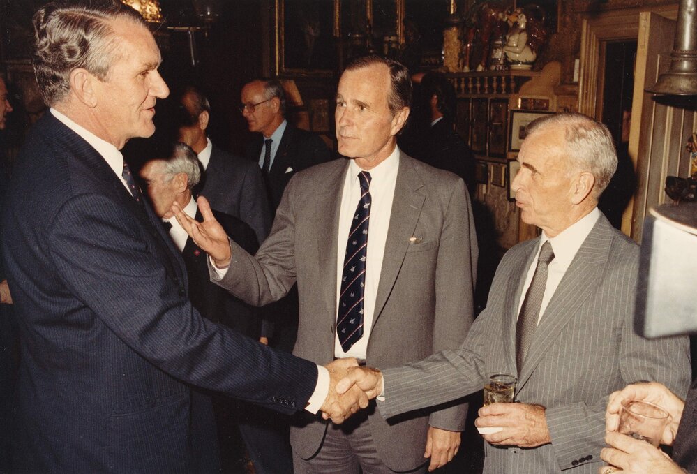 The Vice President of the United States George Bush introducing an unidentified man to Malcolm Fraser during the Prime Minister's official visit to Washington USA in May 1982.