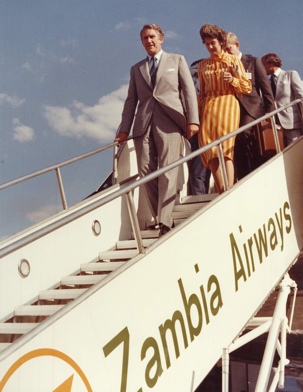 Prime Minister Malcolm Fraser and Tamie Fraser alighting from an aircraft on their arrival in Zambia.