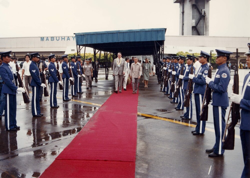 Malcolm Fraser and the Philippines Prime Minister Cesar Virata walking the red carpet together on Mr Fraser's departure from the Philippines.